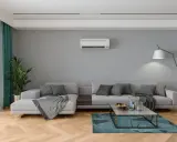 Salon moderne avec canapé gris, tapis bleu, et climatisation souffle froid en mode chauffage.