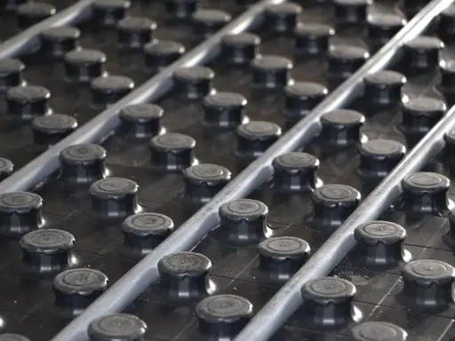 Système de chauffage au sol avec tuyaux gris sur des plots noirs. Une solution efficace pour le chauffage avec une pompe à chaleur.