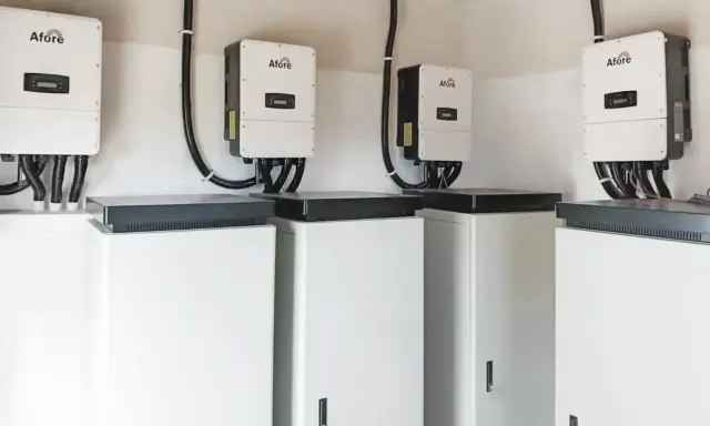 Plusieurs onduleurs Afore sont installés au-dessus de caissons blancs. Ces appareils sont essentiels pour la définition d'un onduleur dans un système d'énergie solaire.