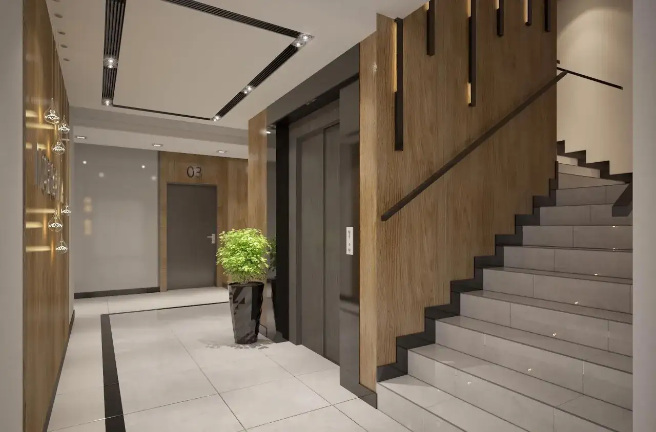 Hall d'entr&eacute;e d'un immeuble moderne avec un ascenseur, un escalier en b&eacute;ton et bois, et des &eacute;clairages design.